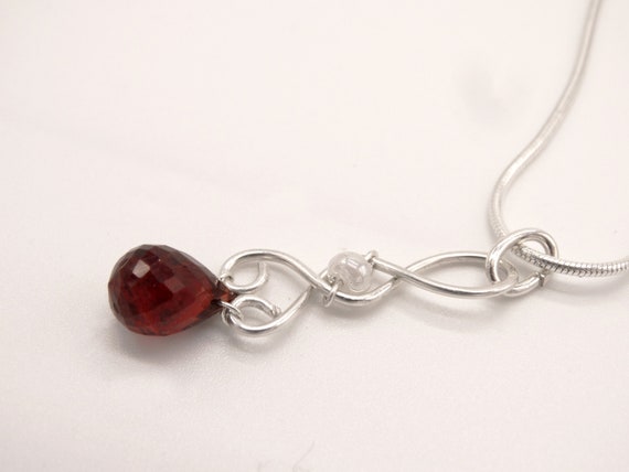 Faceted AAA garnet teardrop in twisted sterling silver, with a sterling snake chain