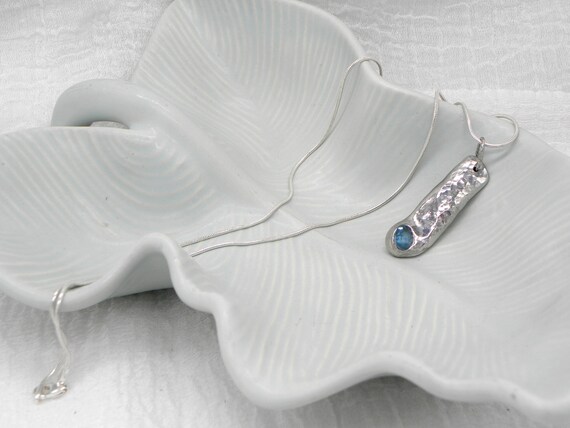 Freeform pewter pendant necklace with embedded, faceted aquamarine and sterling silver snake chain
