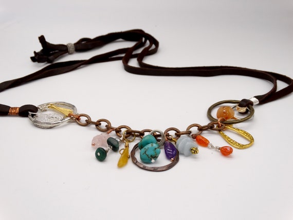 This adjustable charm necklace is leather, gemstones, a variety of metals, shapes and textures - as fun as they come!
