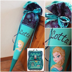 Könnte beinhalten: Eine türkisfarbene und lila Schultüte mit einem Cartoon-Bild von Elsa aus Frozen. Die Tüte ist mit einem Schneeflockenmuster und dem Namen "Lotta" verziert. Türkisfarbene Bänder und ein passender Rucksack sind ebenfalls zu sehen.