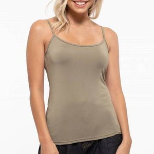 May include: A light brown sleeveless tank top with a scoop neck.