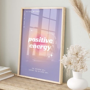 May include: A motivational poster with a purple background and a window with a pink and orange gradient. The text on the poster reads "NO FEAR, NO LIMITS", "YES GIRL YOU CAN", "positive energy", and "THE UNIVERSE WILL SUPPORT YOU IN EVERY WAY."