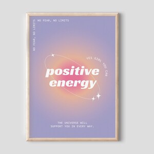 May include: A motivational poster with a purple and pink gradient background. The text "YES GIRL YOU CAN" is in a circle with stars. The text "positive energy" is in bold white letters. The text "NO FEAR, NO LIMITS" is at the top of the poster. The text "THE UNIVERSE WILL SUPPORT YOU IN EVERY WAY." is at the bottom of the poster.