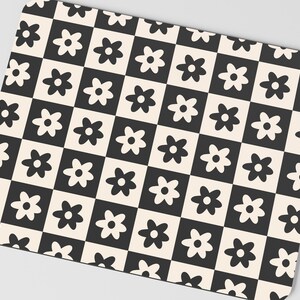 May include: Black and white checkered mouse pad with a repeating pattern of stylized flowers.