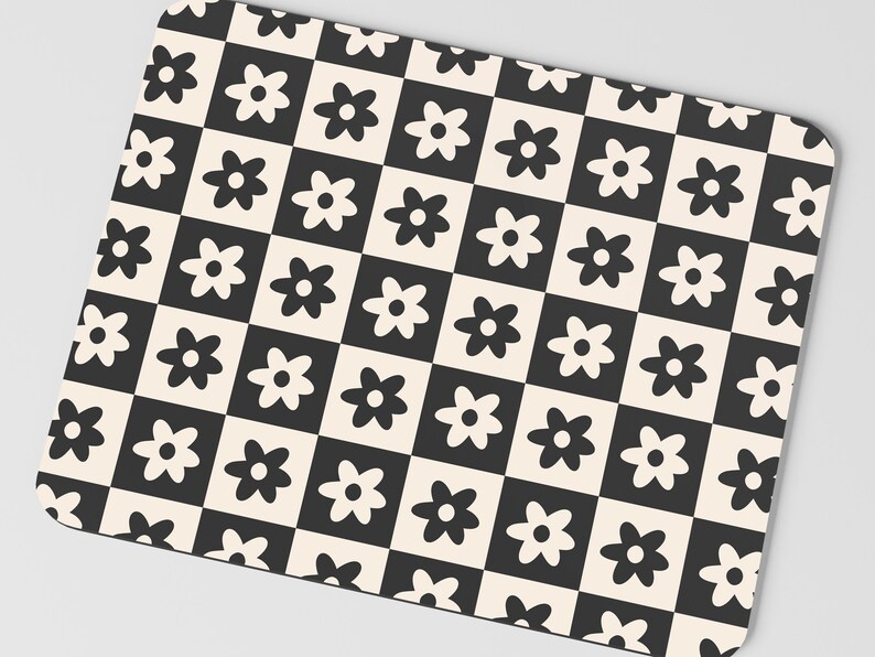 May include: Black and white checkered mouse pad with a repeating pattern of stylized flowers.