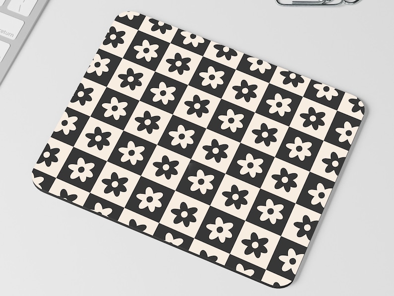 May include: Black and white checkered mouse pad with a repeating pattern of stylized black flowers.