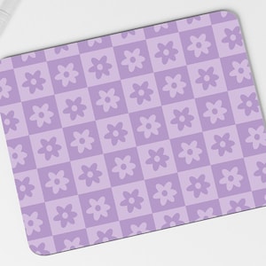 May include: A purple and white checkered mouse mat with a repeating pattern of stylised flowers.