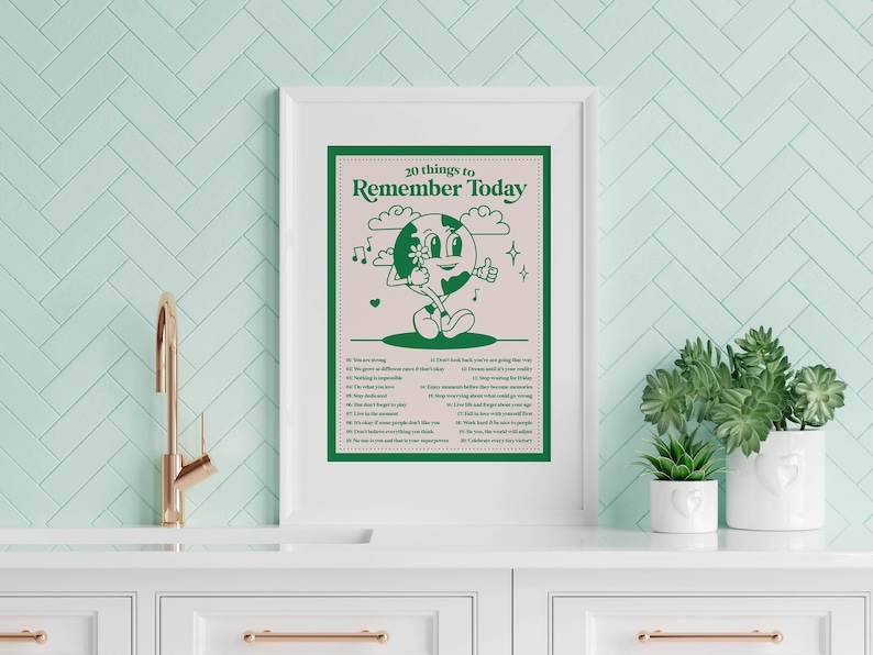 May include: A framed poster with a green cartoon character on a pink background. The poster says "20 things to remember today" and lists 20 affirmations.