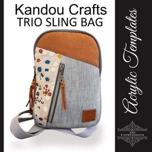 May include: A gray and brown Trio Sling Bag with a floral pattern and a leather patch. The bag has a zipper closure and a shoulder strap. The text "Kandou Crafts TRIO SLING BAG" is at the top.