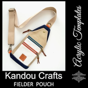 May include: A beige and navy blue Fielder Pouch with a white panel and red and teal stripes. The bag has a beige strap and a small leather patch. The text "Kandou Crafts" and "Fielder Pouch" are at the bottom of the image.
