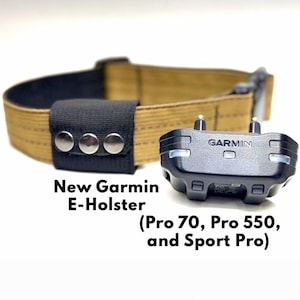 May include: A tan nylon collar with a black fabric attachment featuring three silver metal snaps, paired with a black Garmin electronic device. Text on the image reads: New Garmin E-Holster (Pro 70, Pro 550, and Sport Pro).