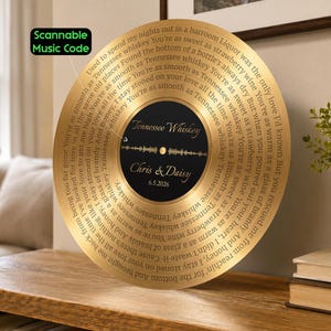 May include: A circular gold-colored plaque resembling a vinyl record, featuring lyrics to the song Tennessee Whiskey spiraling around the center. The black center label displays the text Tennessee Whiskey, Chris & Daisy, 6.5.2026, and a sound wave.