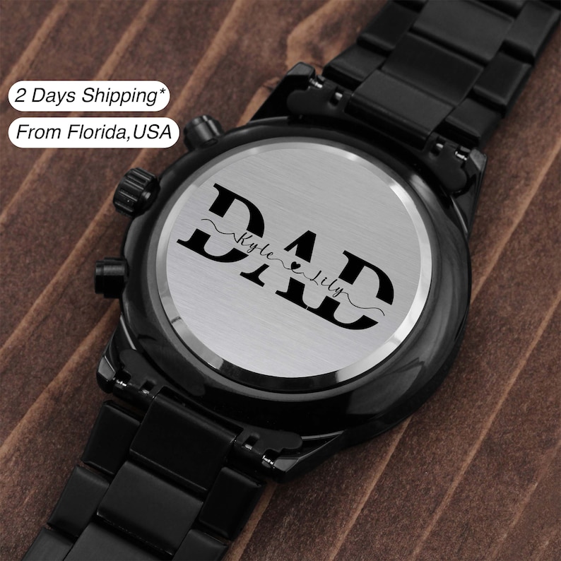 May include: Black wristwatch with a silver face and a personalized inscription that reads "DAD" with the names "Kyle" and "Lily" underneath.