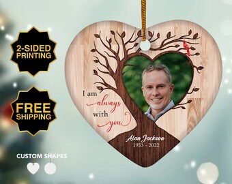 May include: A heart-shaped wooden ornament with a tree and a photo of a man inside the heart. The ornament has the text "I am always with you" and "Alan Jackson 1953-2022".