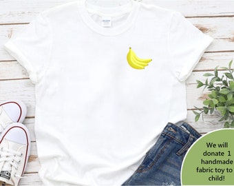 May include: White t-shirt with a bunch of yellow bananas on the front. The text "We will donate 1 handmade fabric toy to a child!" is on a green background in the bottom right corner of the image.