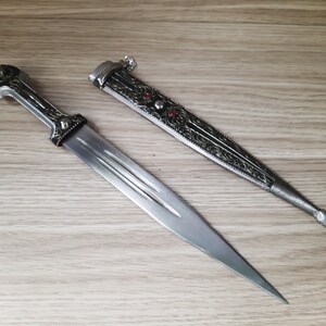 Handmade dagger 13 inches long, in silver and black, with ornaments and red plastic resembling a gemstone