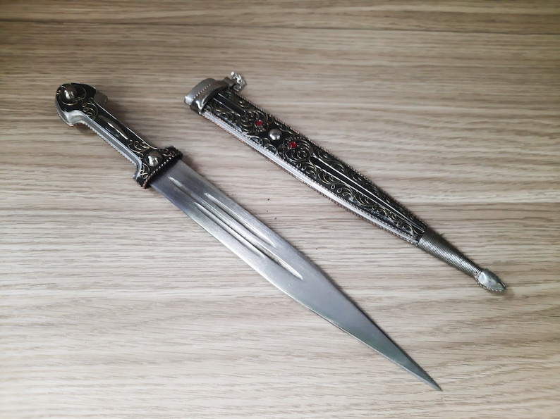 Handmade dagger 13 inches long, in silver and black, with ornaments and red plastic resembling a gemstone