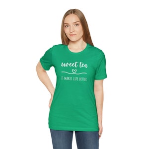 May include: A green t-shirt with white text that reads "sweet tea it makes life better" with a small heart symbol above the word "tea".