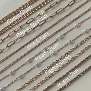 May include: Close-up of eight different gold chain styles, including curby chain, paperclip chain, vine chain, pearl chain, figaro chain, and rope chain.