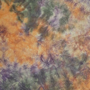 May include: A fabric surface featuring a tie-dye pattern with blended shades of orange, deep purple, and dark forest green. The textile displays a woven texture with an organic, swirling color distribution across the entire visible area.