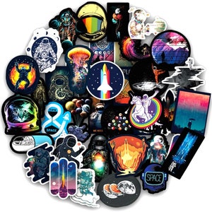 May include: A selection of vibrant space-themed stickers, depicting astronauts, planets, rockets, and other cosmic elements. The stickers feature diverse designs, such as a cat in a space helmet, a jellyfish, and a unicorn on a rainbow. The colour scheme includes blues, oranges, and purples.