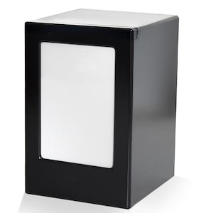 May include: Black rectangular napkin holder with a clear plastic window to view the napkins.