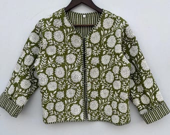 May include: A green quilted jacket with a white floral print. The jacket has a zipper closure and a stand-up collar.