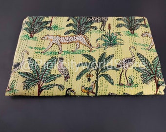 May include: A yellow kantha quilt with a jungle print featuring leopards, zebras, birds, and palm trees.