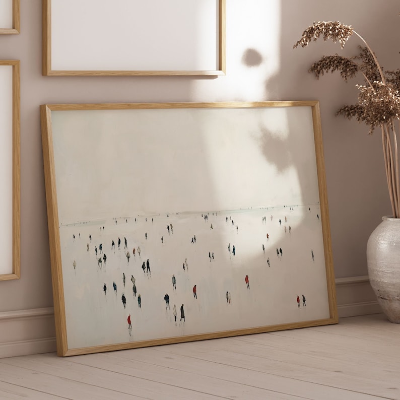 May include: A framed painting of a foggy beach scene with many people walking on the sand. The painting is in a light wood frame and has a white background.
