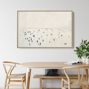 May include: A minimalist painting of a crowd of people in muted colors walking on a white surface. The painting is framed in a light wood frame.