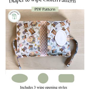 May include: A Diaper & Wipe Clutch Pattern PDF document featuring a light-colored fabric with a print of cowboy boots, hats, and flowers. The clutch has a white plastic wipe dispenser opening and includes three distinct wipe opening styles.