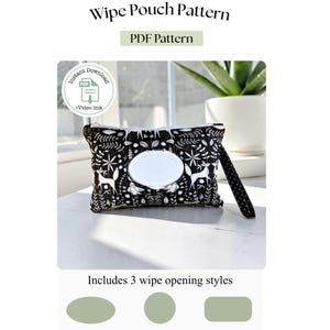 May include: A black and white wipe pouch with a woodland pattern, featuring deer and floral designs. The pouch has a white oval opening for wipes and a black strap. The image includes text that says "Wipe Pouch Pattern" and "PDF Pattern".