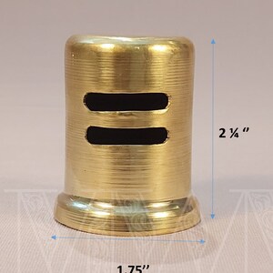 May include: A gold-colored metal vent cover with two rectangular openings. The vent cover is 2 1/4 inches tall and 1.75 inches wide.
