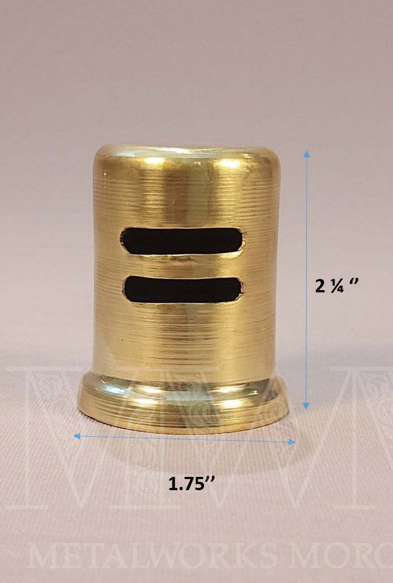 May include: A gold-colored metal vent cover with two rectangular openings. The vent cover is 2 1/4 inches tall and 1.75 inches wide.