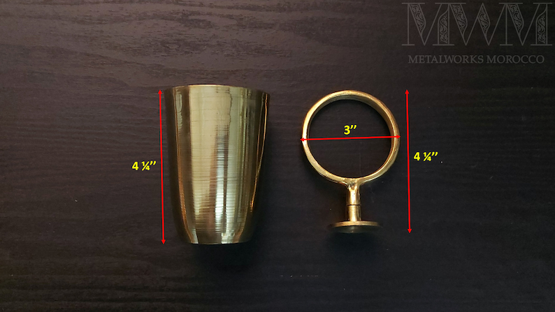 May include: A gold metal cup holder with a 3-inch diameter ring and a 4 1/4-inch height. The cup holder is made of solid brass and has a polished finish.