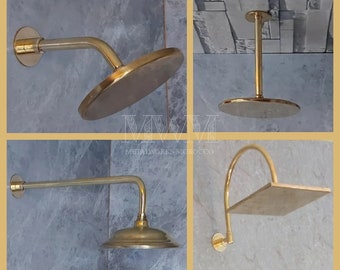 May include: Four gold-colored shower heads with different styles and mounting options. The shower heads are shown against a tiled background.