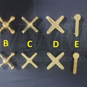 May include: Nine different styles of gold-toned metal faucet handles. The handles are labelled A through G.