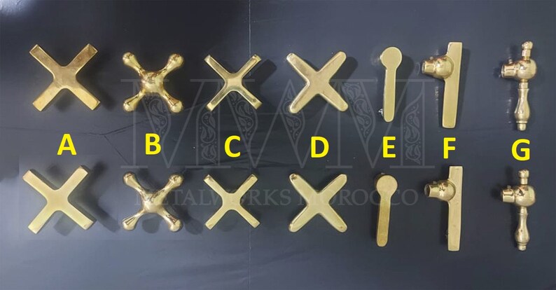 May include: Nine different styles of gold-toned metal faucet handles. The handles are labelled A through G.