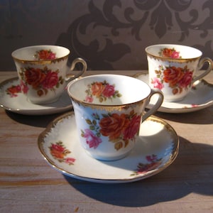 Porcelain cups and saucers Royal Bavaria, richly decorated with flowers and a gold rim
