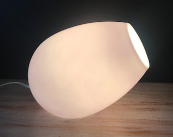 May include: A white, egg-shaped table lamp with a soft, diffused glow.