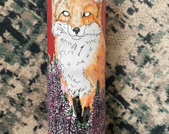 May include: Red candle with a hand-drawn illustration of a fox in a field of purple flowers.