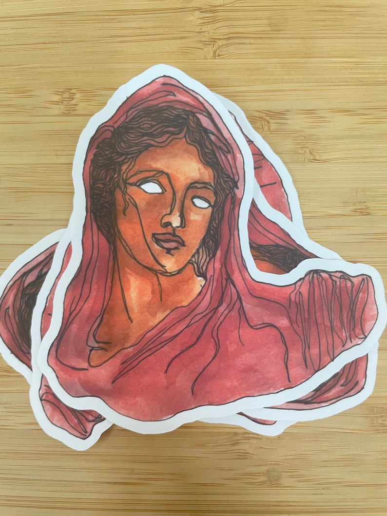 Op de afbeelding: Een sticker van een vrouwen gezicht met witte ogen, die een rode sjaal draagt. De sticker is op zichzelf gelegd, waardoor een 3D-effect ontstaat.