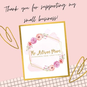 May include: A gold frame with a white background and a pink watercolor floral wreath. The text "The Artisan Mum" is in the center of the wreath, with the text "Personalised Crafting" below it.
