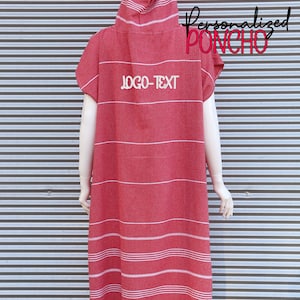 May include: A red hooded poncho featuring thin white horizontal stripes and white fringe at the bottom hem. The garment displays the text "LOGO-TEXT" in white on the upper back, with "Personalized PONCHO" written in black and red script nearby.