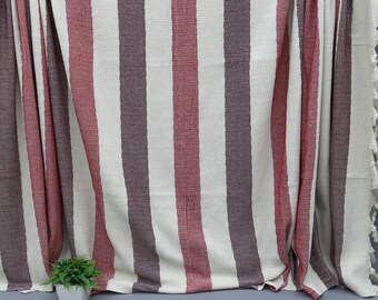 May include: A striped throw blanket with red, white, and brown stripes. The blanket has a fringe border and is made of a soft, woven fabric.