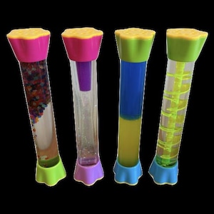 May include: Four colorful sensory tubes with clear plastic cylinders. Each tube has a different design: one with small beads, one with glitter, one with blue and yellow liquids, and one with a yellow spiral. The tubes have pink, green, purple, and blue accents.