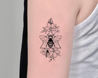 Bee  flowers tattoo on the inner arm