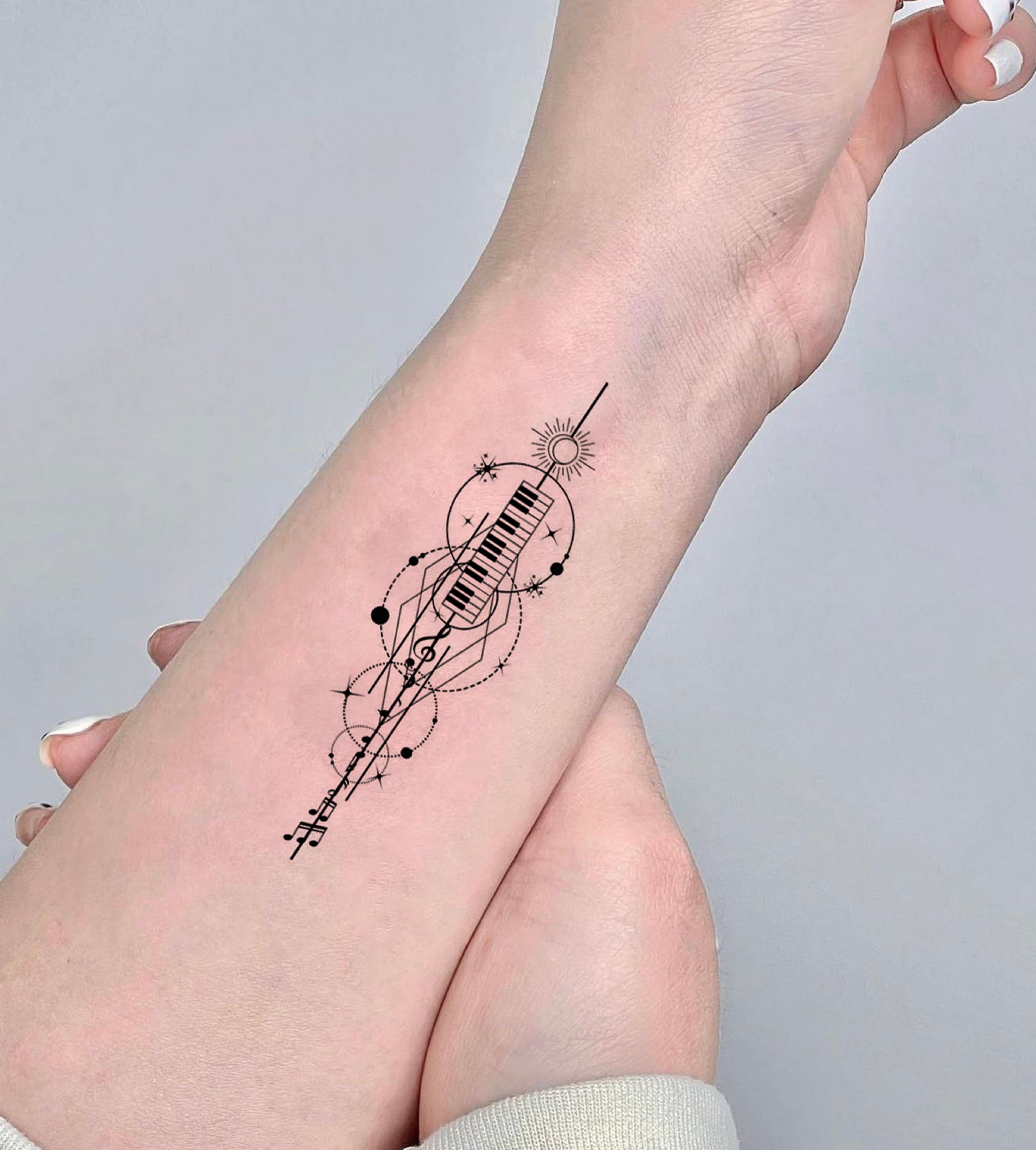 Mist Ink Tattoo - Sexy Music notes tattoos on girl's wrist. This is a tattoo  which is simple yet sexy. The tattoo is of a simple music notes tattoo on a  lady's