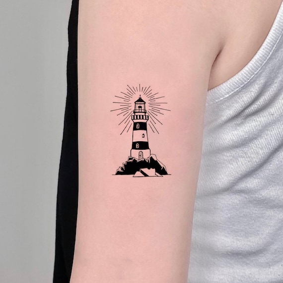 Healed lighthouse tattoo located on the inner forearm,