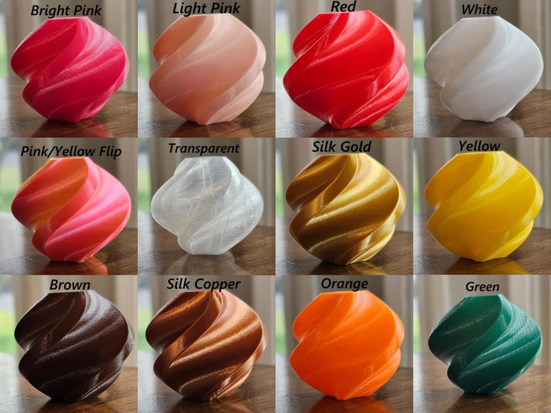 May include: Twelve 3D printed plastic spheres in various colors, including bright pink, light pink, red, white, pink and yellow, transparent, silk gold, yellow, brown, silk copper, orange, and green.